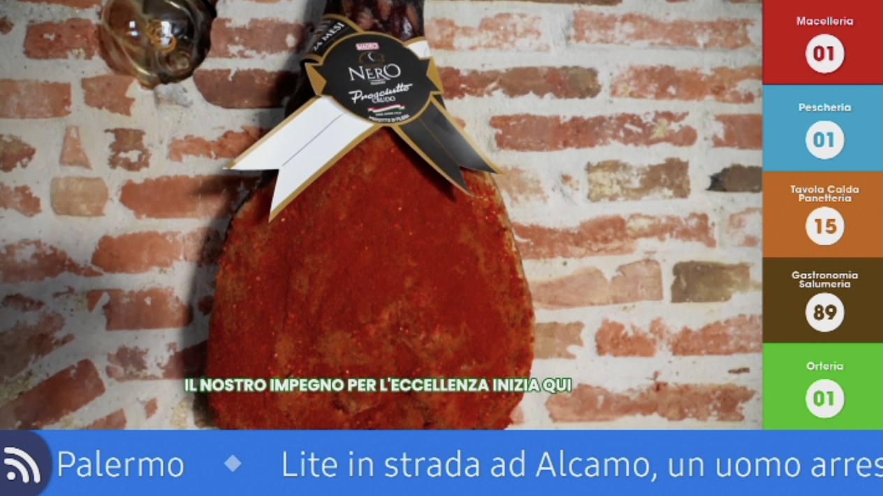 In-store display: the content on air, the column of numbers called for the Butcher, Fishmonger, Hot food, Delicatessen and Greengrocer counters, and the news ticker along the bottom.